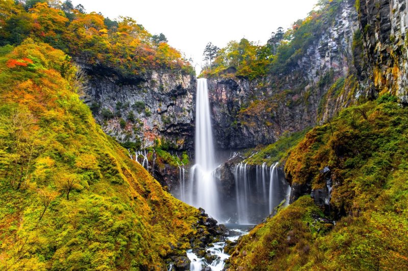 Kegon Waterfall In Autumn Trees Colorful Waterfall From Lake Chuzenji In Nikko National Park , Against White Isolated Sky , Beautiful In Autumn Season At Tochigi,japan