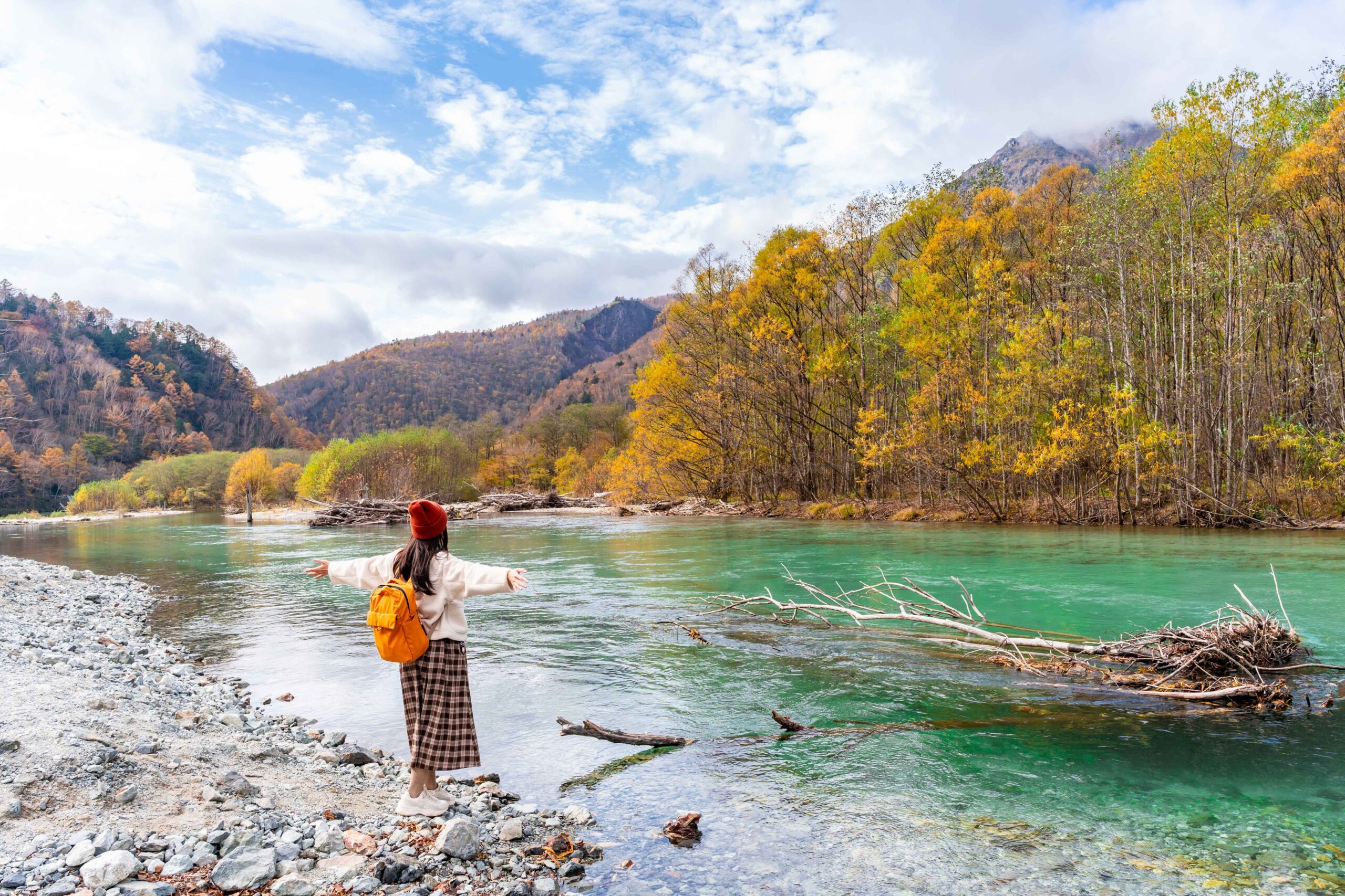Young Female Tourist Relaxing And Enjoying With Beautiful Nature Autumn Foliage At Kamikochi In Japan